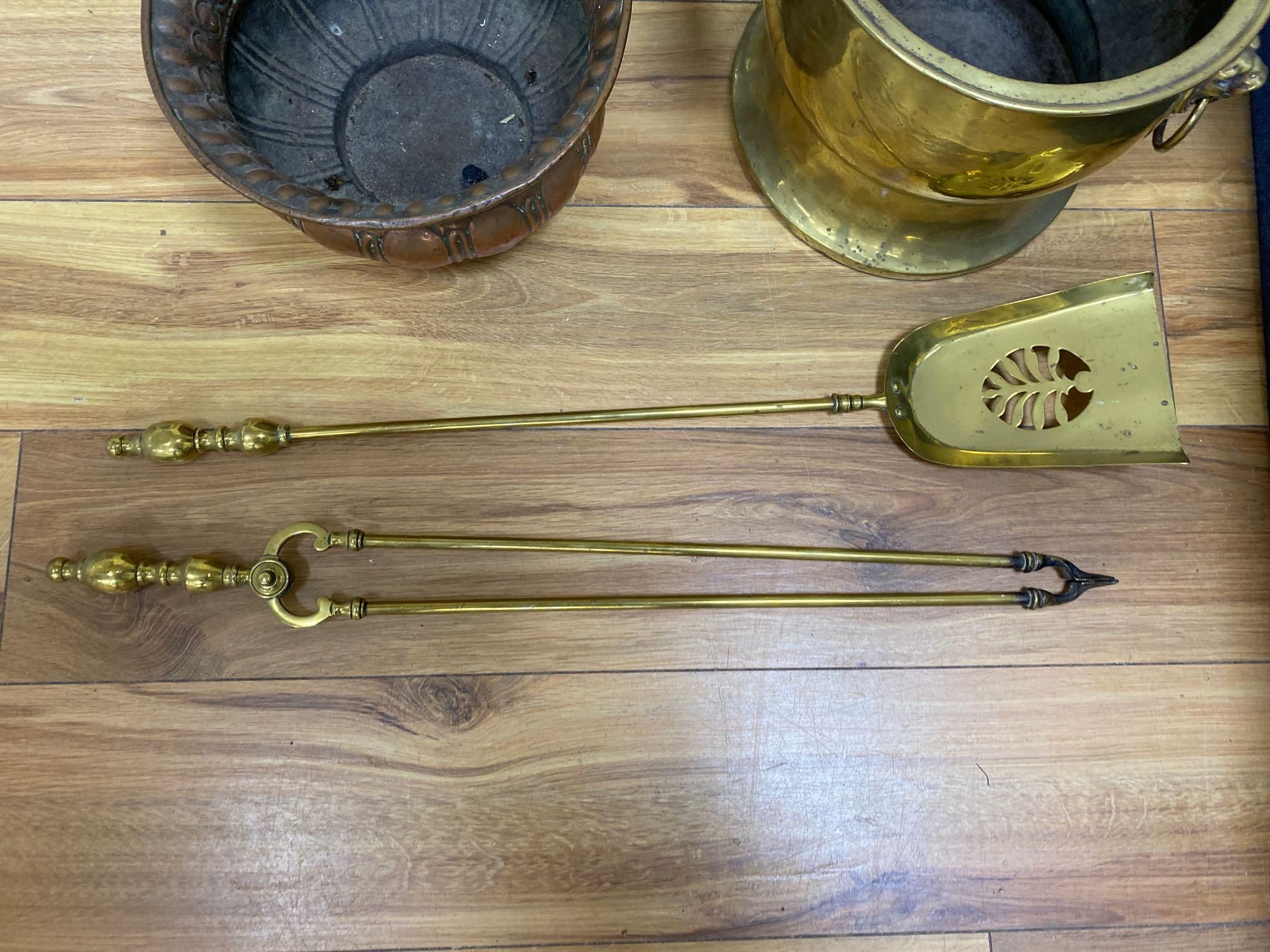 A wrought iron fire grate, two coal bowls and a pair of fire brasses